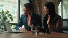 Arabian business team talking video call cheerful presenting good result startup data diagram briefing negotiation internet conference chatting Muslim businessman businesswoman two office colleagues - Powered by Shutterstock - Get 15% off with code: PIKWIZARD15