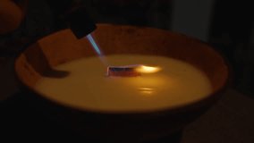 Blue Flame Torch Lighting Wooden Wick in Coconut Candle, close angle, Cozy Home Decor Concept. - Powered by Shutterstock - Get 15% off with code: PIKWIZARD15