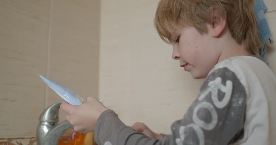 Boy Brushes Teeth in Bathroom in the Morning. 4K 10-bit