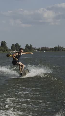 Man falling into water from water board on waves