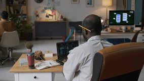 Talented African American programmer making presentation via laptop turning in office chair and breaking into smile while looking at camera - Powered by Shutterstock - Get 15% off with code: PIKWIZARD15