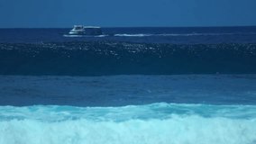Slow motion video of ocean wave, paddling surfer and cargo ship moving in distance. - Powered by Shutterstock - Get 15% off with code: PIKWIZARD15