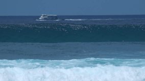 Slow motion video of ocean wave, paddling surfer and cargo ship moving in distance. - Powered by Shutterstock - Get 15% off with code: PIKWIZARD15