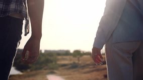 Close-up of young couple gently holding hands in warm sunlight. Romantic and emotional moment symbolizing love, intimacy, trust, and togetherness.  - Powered by Shutterstock - Get 15% off with code: PIKWIZARD15