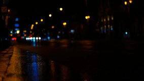 Wet asphalt reflecting city lights at night with passing cars. City lights reflecting on wet asphalt at night, with passing cars creating streaks of light and color - Powered by Shutterstock - Get 15% off with code: PIKWIZARD15
