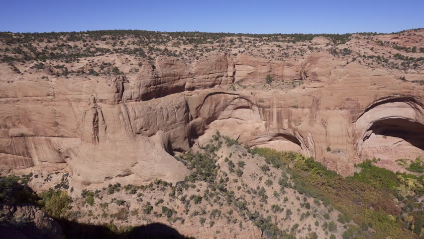 Navajo National Monument in Navajo Nation territory, Arizona. Betatakin ruins in Betatakin Canyon with autumn aspen. One of three well-preserved cliff dwellings of the Ancestral Puebloan people.
