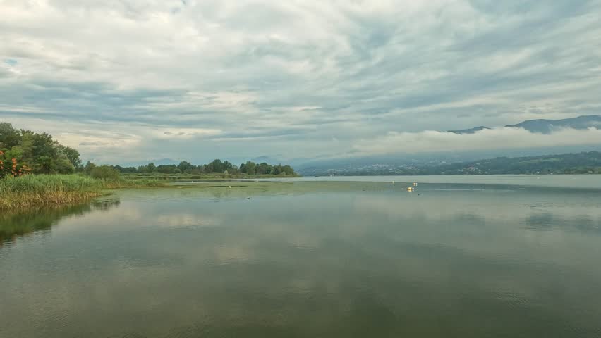 clouds reflected on the lake water on a rainy morning