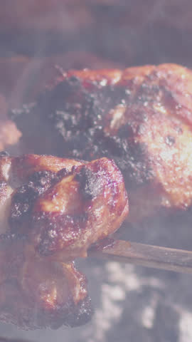 Raw meat slices rotate slowly on a spit above glowing embers, caught in slow motion. The charred edges, juicy texture and dramatic firelight evoke intensity, rustic cooking and primal grilling appeal.