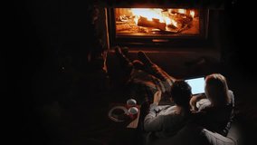 A Young Couple Uses A Tablet In Their House By The Fireplace A Nice Evening Together 4k video - Powered by Shutterstock - Get 15% off with code: PIKWIZARD15