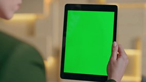 Hand Holding Digital Tablet With Green Screen Display - Powered by Shutterstock - Get 15% off with code: PIKWIZARD15
