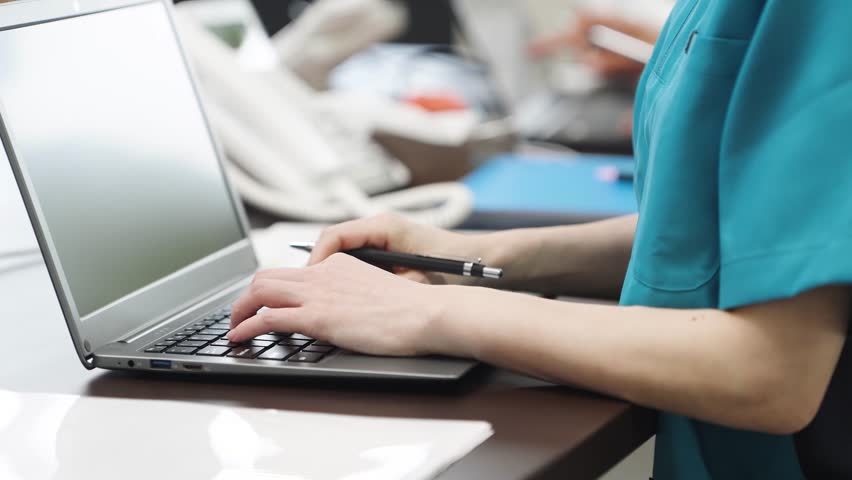 Hands of an Asian caregiver doing clerical work