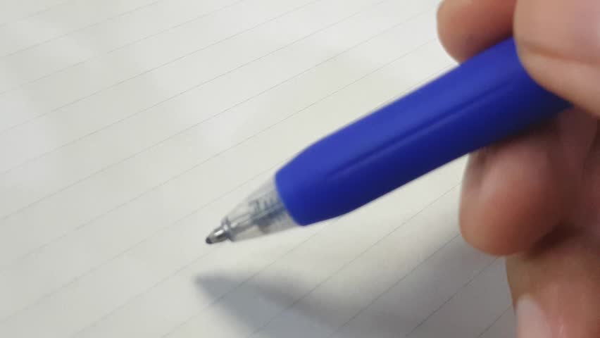 Close-up footage of a hand writing the motivational phrase never give up on lined notebook paper. Inspirational message, positive encouragement concept, ideal for education, success, and personal grow