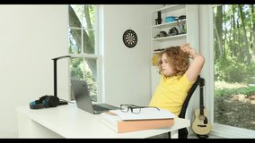 Kid using laptop for online studying at home. Child sitting at desk with laptop on online school lesson. Child online learning with laptop. Young student watch online class on laptop. - Powered by Shutterstock - Get 15% off with code: PIKWIZARD15