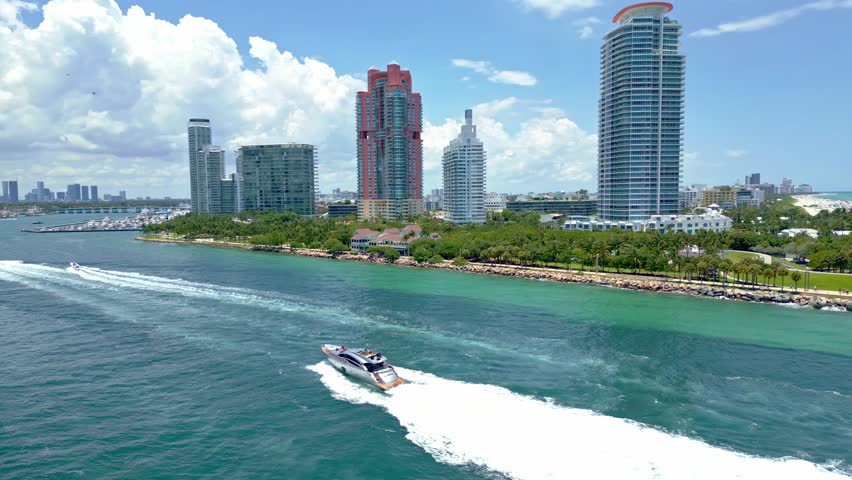 Miami skyline from above. Luxury yacht in Miami. Aerial view of Miami South Beach. Boats along the Miami coast. Oceanfront city panorama. Drone flying over city. .Sunny day in Florida. South Point.