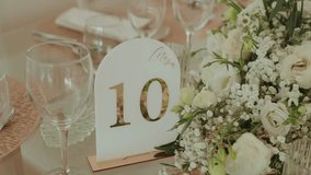 elegant wedding table number with flowers and glassware arrangement - Powered by Shutterstock - Get 15% off with code: PIKWIZARD15