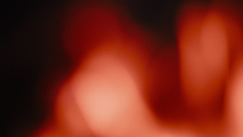 bokeh filmburn overlay from blurred flames in real campfire, use as transition or filmburn effect