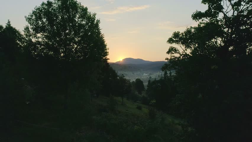 Nice sun rise under green valley. Sunrise illuminates a lush green valley with soft golden light. misty morning atmosphere creates a serene and hopeful landscape. ideal for nature themes