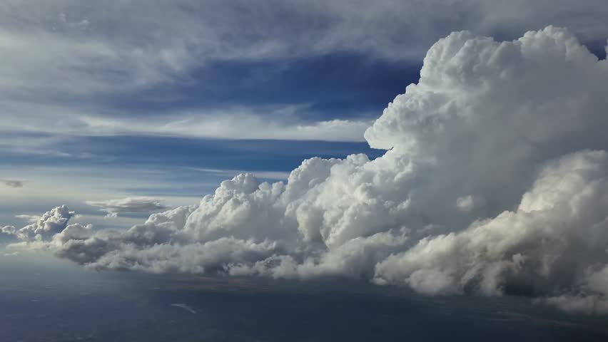An immersive perspective from an airplane cockpit while flying toward a theatening storm cloiud in a blue sky, A pilot’s perspective flying into the unknown. ultra-realistic 4K