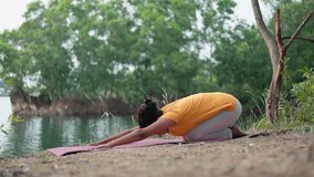 A woman practicing yoga exercises changing child pose to cobra pose at outdoor during blue hour twilight. - Powered by Shutterstock - Get 15% off with code: PIKWIZARD15