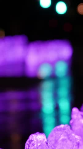 Close-up of fountain jets as lighting shifts to warmer tones