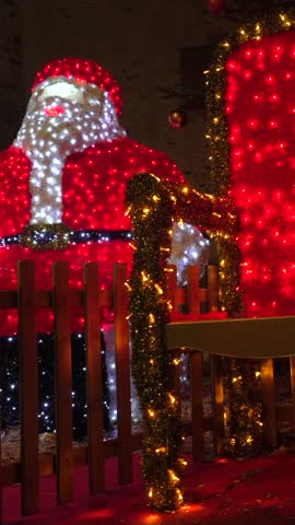 Santa claus, made of christmas lights, vanishes from his throne in bayonne, france, creating a magical holiday scene