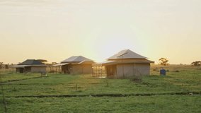 Sunrise early morning warm orange light in glamping tent camp in Africa safari. Sunlight shining bright in Tanzania in Serengeti national park. Vacation trip with game drive watching outdoors - Powered by Shutterstock - Get 15% off with code: PIKWIZARD15