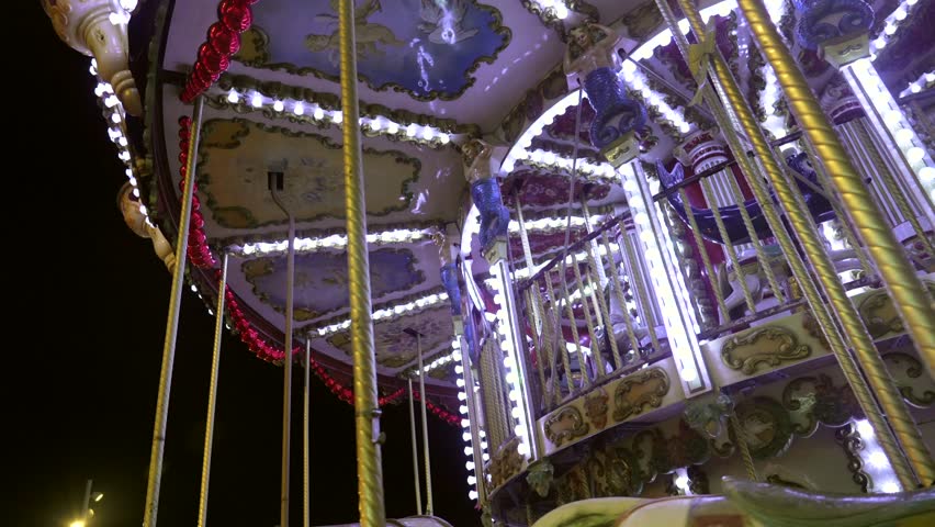 Colorfully lit carousel spins in bayonne, france, creating a festive atmosphere for the holiday season