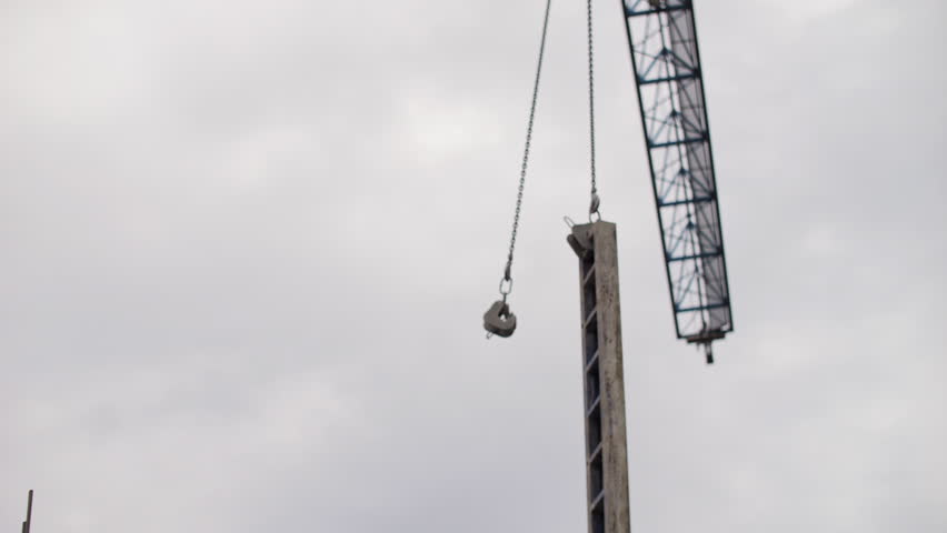 Construction Crane Lifting Formwork Panel at Building Site - Powered by Shutterstock - Get 15% off with code: PIKWIZARD15
