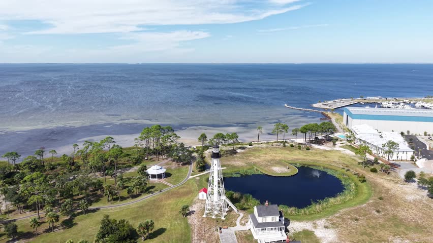 Panoramic drone fly at coastal side of Port St. Joe with Cape San Blas Lighthouse with small artificial pond, Gulf County, Florida, USA