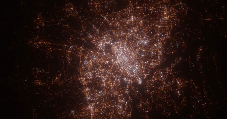 Turku (Finland) top view at night. Aerial view on modern city with lights. Camera is flying above the city, moving backward. Vertical video. The north is on the left side