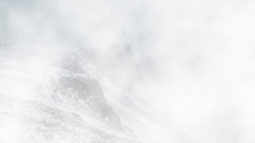 Snow Covered Mountain Peaks in Heavy Winter Storm, Misty Snowy Mountains with Dense Winter Clouds