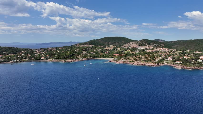 flying across Agay Bay, French Riviera (Côte d'Azur) with Cap Esterel, Beaches, "Plage de Camp Long" and "Plage du Pourrousset" as well as Cap Dramont, a nature preserve - 4k aerial video footage
