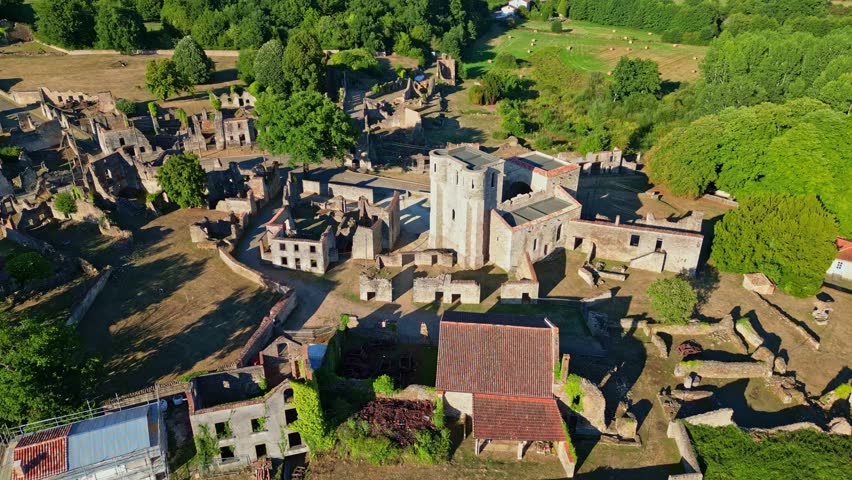 Drone view of medieval buildings at Village martyr d'Oradour-sur-Glane and ruins with central destroyed church, Haute-Vienne, France.