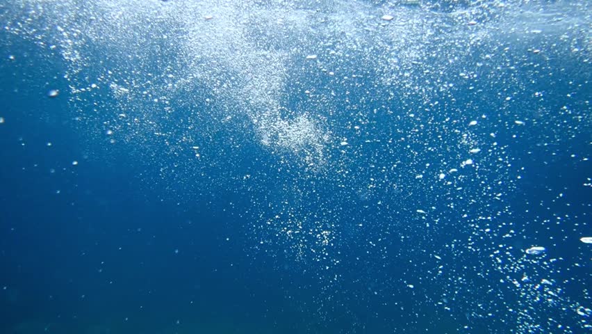 Underwater bubbles background, Real photo of air bubble under the sea, Light and sunlight underwater in ocean and sea, Abstract oxygen bubbles rising in water surface, Sun light rays undersea deep.