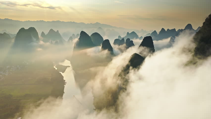 Aerial shot of beautiful karst mountain with river and clouds natural landscape at sunrise in Guilin, China.