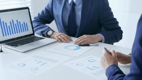 Businessman discussing financial data with female partner on a laptop while analyzing charts and market trends in office. Business people concept - Powered by Shutterstock - Get 15% off with code: PIKWIZARD15