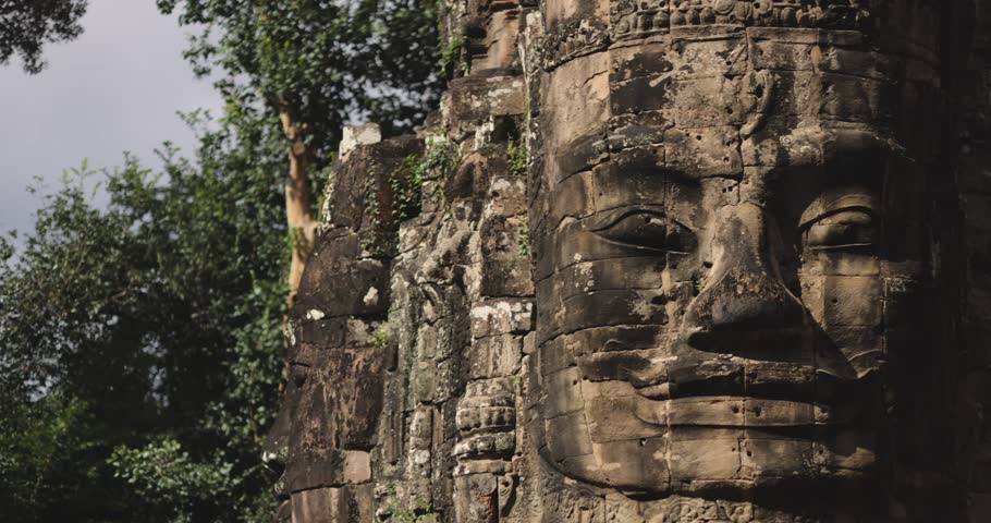 Cinematic video of a giant stone face at Bayon Temple, Cambodia, with smooth camera movement. Perfect for history, culture, lifestyle, travel promo, and heritage tourism footage in high quality.