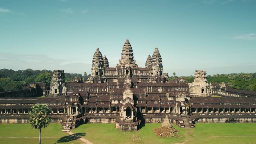 High quality drone footage of Angkor Wat in Cambodia, showing temple towers and lush greenery. Great for tourism promo, cultural heritage projects, travel ads, and historical concept videos.
