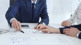 Corporate team reviewing financial data, collaborating around digital tablet and paperwork, analyzing market trends in modern office setting with professional demeanor - Powered by Shutterstock - Get 15% off with code: PIKWIZARD15