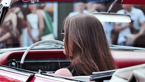 Woman driving vintage convertible car looking in the rearview mirror - Powered by Shutterstock - Get 15% off with code: PIKWIZARD15