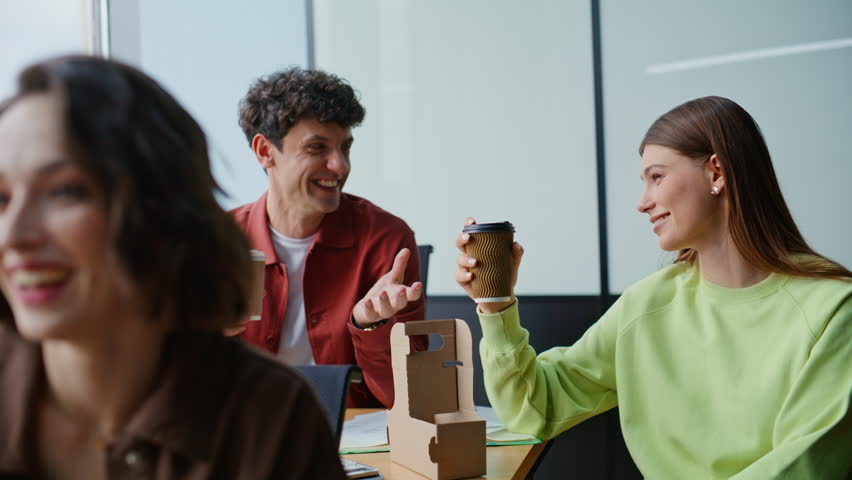 Colleagues group coffee break at workspace closeup. Smiling business team holding tea takeaway talking in modern office. Happy creative teammates clinking cupboard cups discussing news in coworking