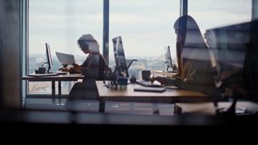 Busy corporate office silhouettes at cityscape window place closeup. Young people working computers feeling involved at creative agency. Men women writing emails typing keyboards together at coworking - Powered by Shutterstock - Get 15% off with code: PIKWIZARD15