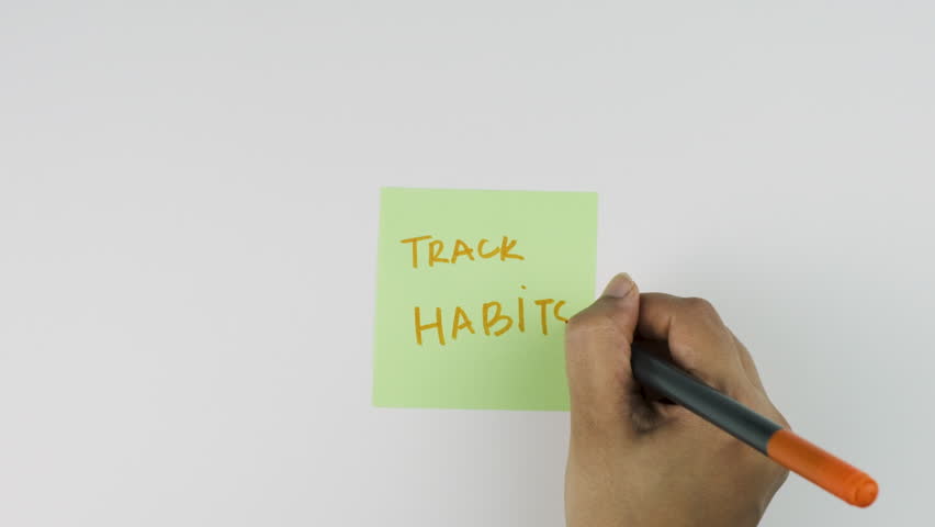 Positive affirmation sticky note with phrase Track daily Habits, daily motivational habits for productivity, journaling, education goals and mindful lifestyle