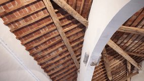 Antique ceiling made of wooden planks and red bricks, white stone arch holding rooftop inside the historical castle, medieval buildings interior construction concept. High quality 4k footage - Powered by Shutterstock - Get 15% off with code: PIKWIZARD15