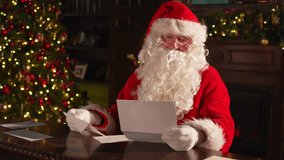 Merry Christmas. Happy Santa Claus reading letters from children in festive Christmas living room. Santa with xmas wish list letter on Christmas eve. Mail of Santa Claus. Winter Holiday Celebrations - Powered by Shutterstock - Get 15% off with code: PIKWIZARD15