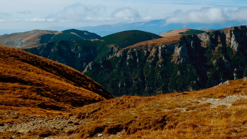 Sinaia Mountain, Transylvania, Romania, summit revealed with rocky outcrops, alpine grasses and wide horizons over rugged highlands
