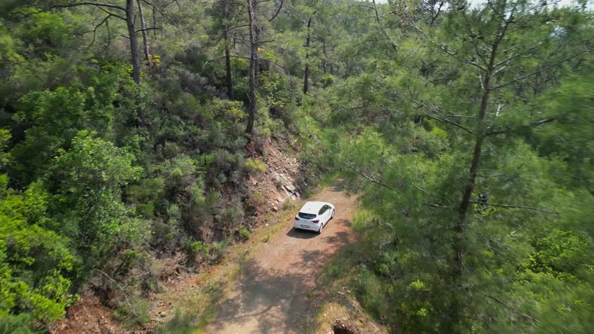 A white car travels on a dirt path in Turkey