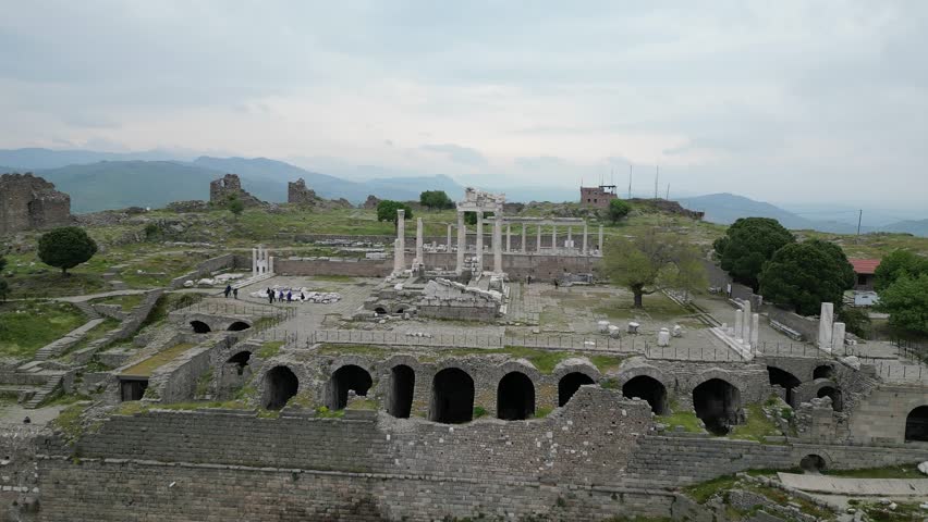 Historic Pergamon acropolis in Turkiye, Turkey seen from above. Partly restored columns and arches tell stories of ancient greatness. A drone view captures history.
