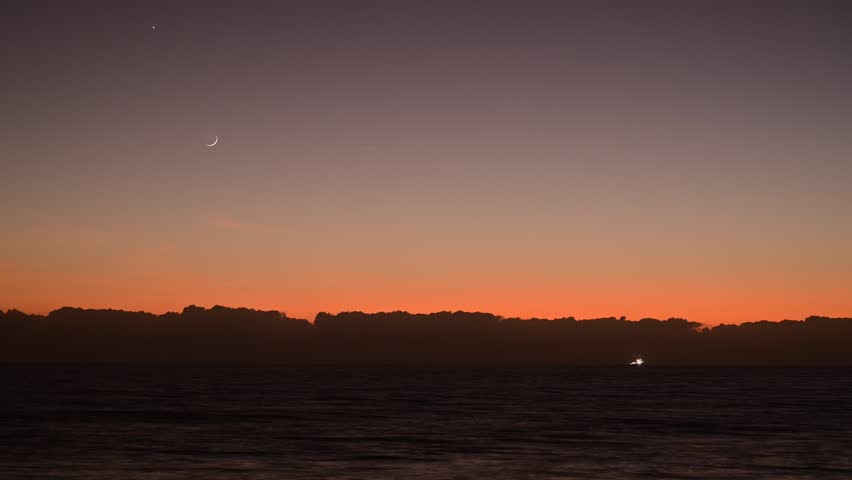 morning light over the Coral Sea in Far North Queensland, Australia, with the moon fading and the sun rising
