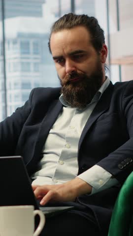 Vertical Video Worried hopeless businessman working under pressure in despair, struggling with corporate downfall and battling the stress of a financial crisis. Business failure and problems. Camera B